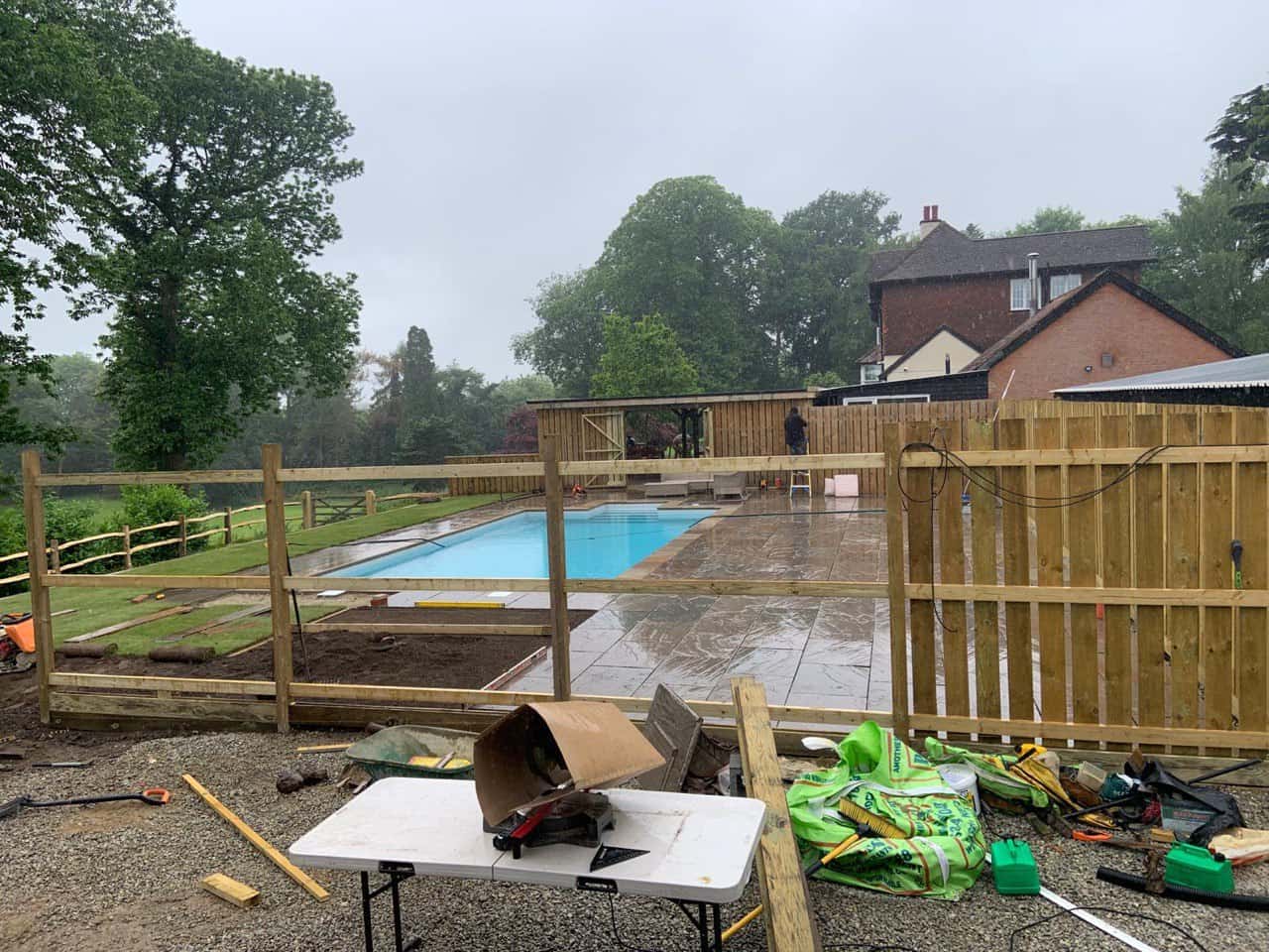 This is a photo of Bespoke custom fencing installed around a swimming pool by Fast Fix Fencing Red Lodge