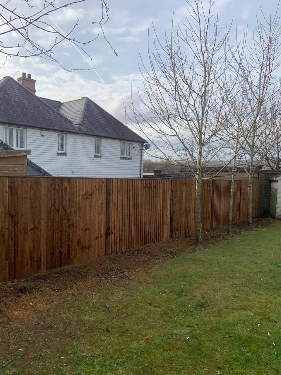 This is a photo of feather edge fencing installed in a residential properties garden by Fast Fix Fencing Red Lodge
