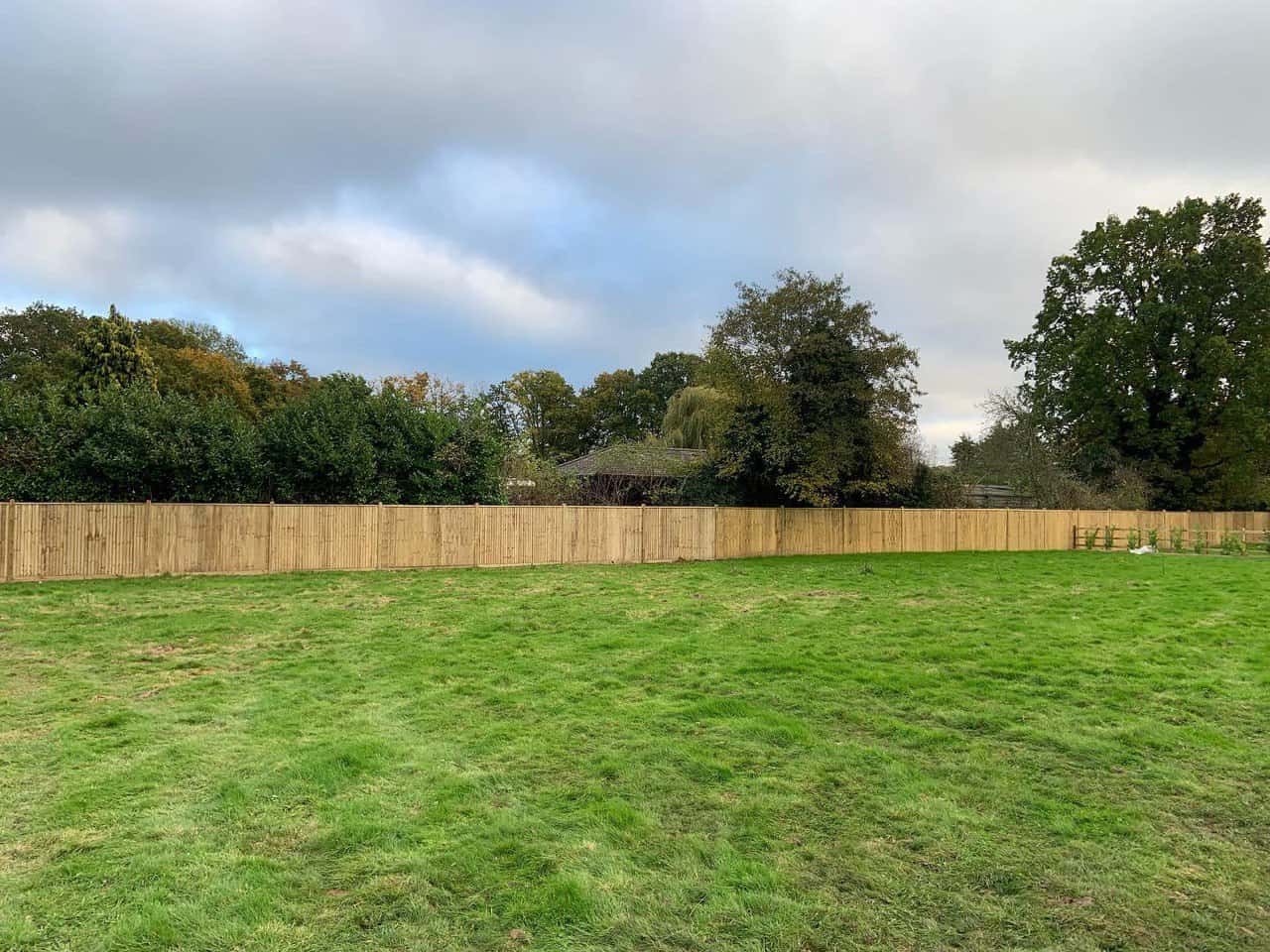 This is a photo of feather edge fencing installed around the edge of a field by Fast Fix Fencing Red Lodge
