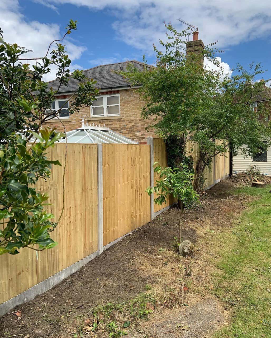 This is a photo of fence panels installed in a residential garden using concrete posts and gravel boards. Installed by Fast Fix Fencing Red Lodge